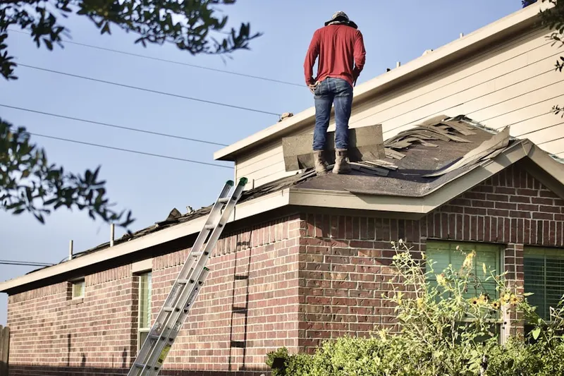 Professional roofer working on a residential roof in Fairway Hill